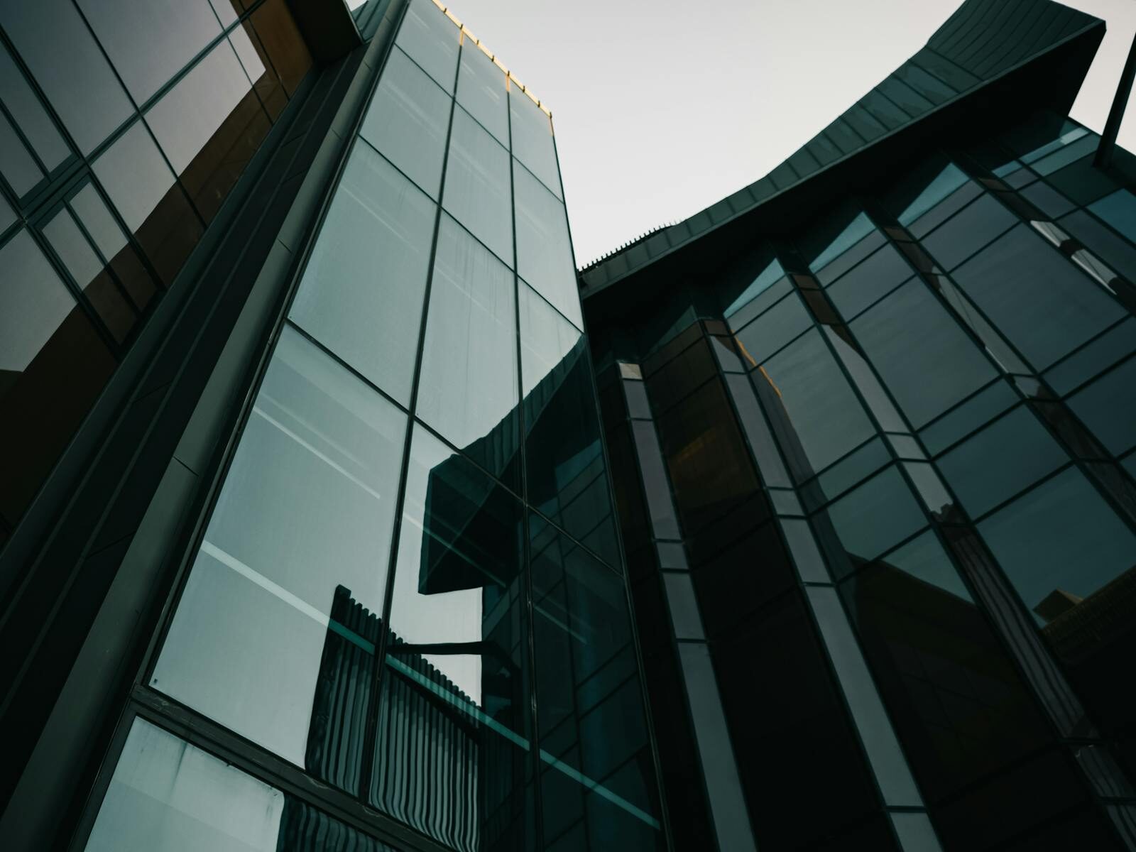 A striking view of modern glass building facades in an urban environment, showcasing contemporary architecture.