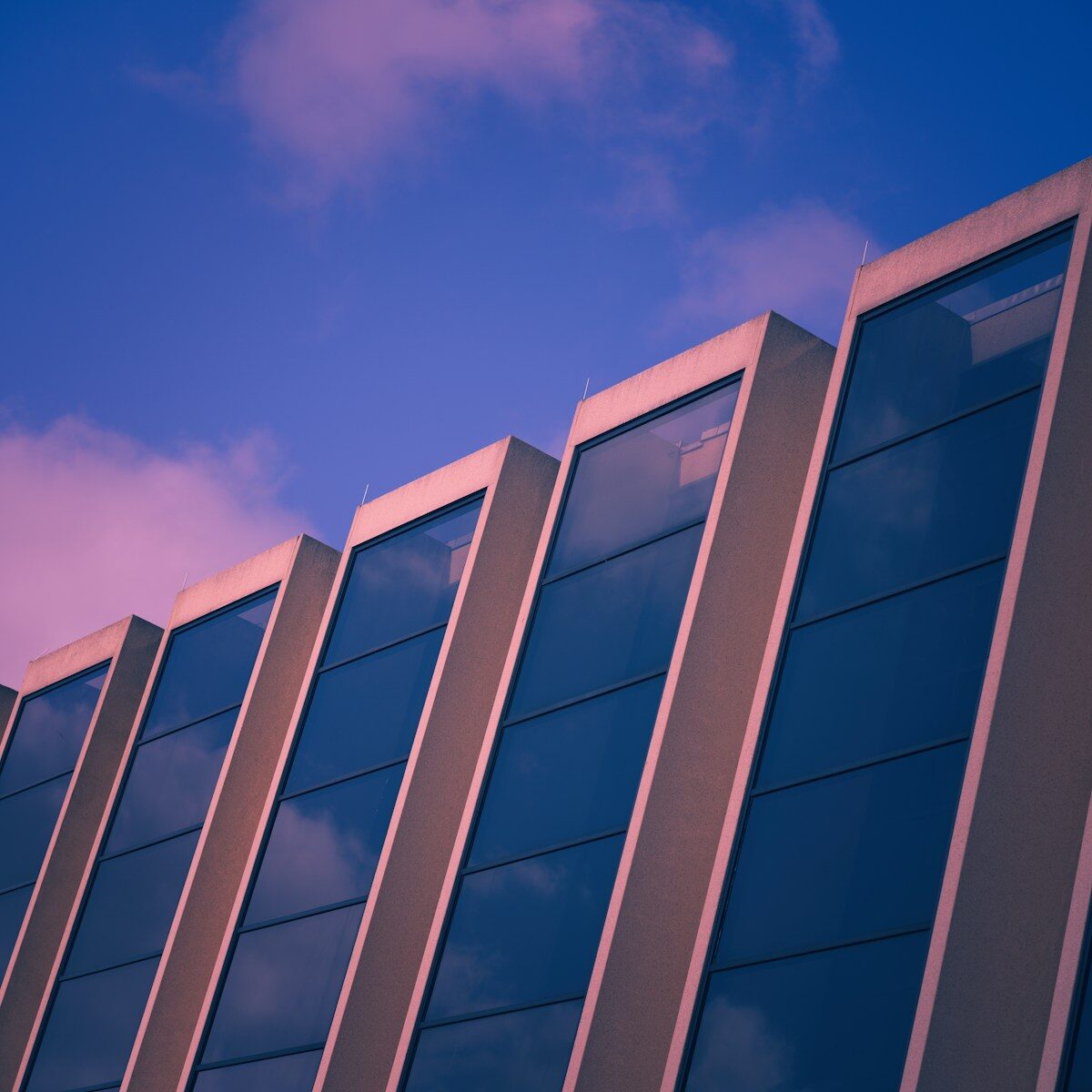 Photo by David Valentine Modern building facade with angled windows against sky